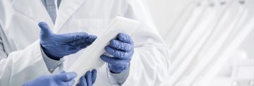 Cropped view of male dentist wearing latex glove