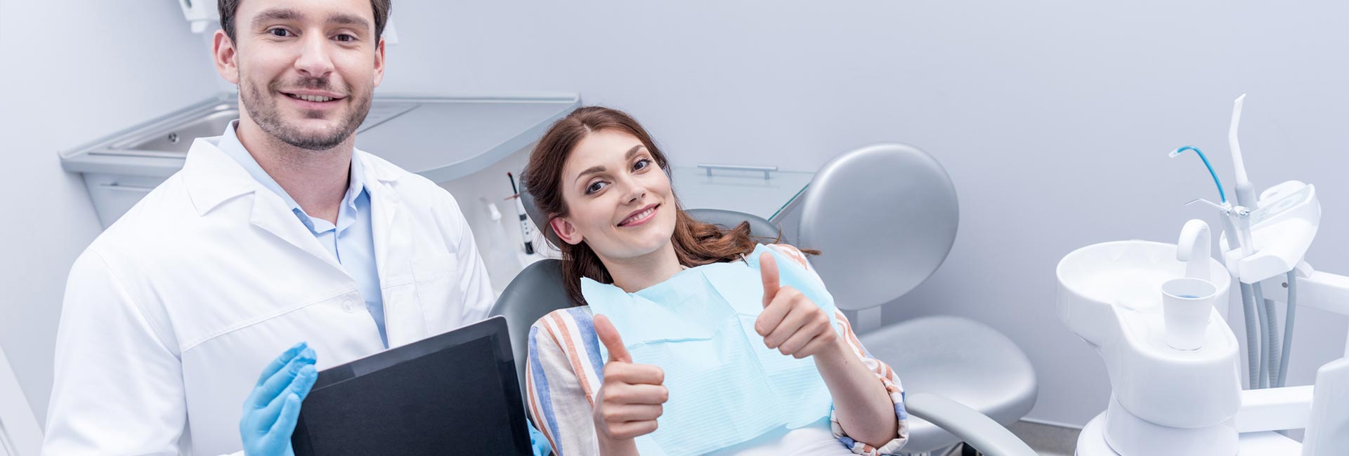 Woman showing thumbs up at the dentist